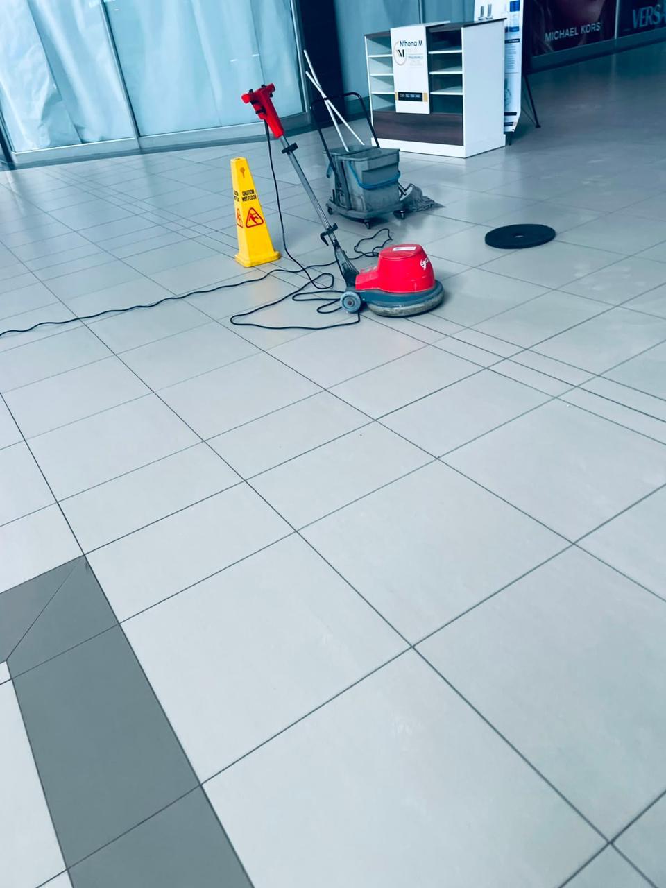 Commercial floor cleaning equipment on a clean tiled floor